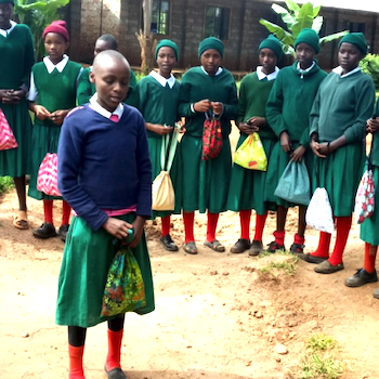 SAG Kit Distribution image showing Gachica School girls receiving 100 kits in Kiganjo, Kenya on Mar 21, 2018