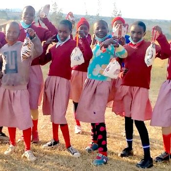 SAG Kit Distribution image showing Lachuta Primary School girls receiving 83 kits in Belle Vue, Kenya on Aug 3, 2021