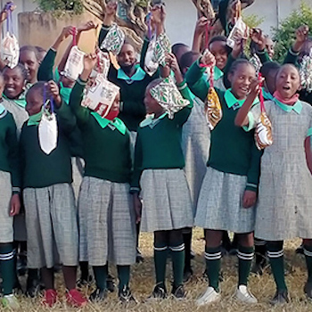 SAG Kit Distribution image showing Chieni Primary School girls receiving 243 kits in Maganjo, Kenya on Aug 5, 2021