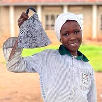 SAG Kit Distribution image showing Lugo Primary School girls receiving 150 kits in Lukomera, Uganda on Nov 17, 2023