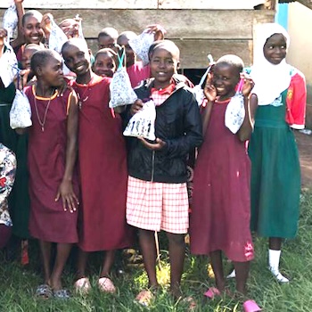 SAG Kit Distribution image showing St. Mark Junior School girls receiving 118 kits in Kayunga, Uganda on Nov 24, 2023