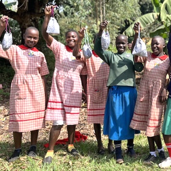 SAG Kit Distribution image showing Kiziba Primary School girls receiving 434 kits in Kikyusa, Uganda on Feb 8, 2024