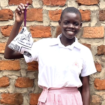 SAG Kit Distribution image showing Childs Care Primary School girls receiving 119 kits in Kikyusa, Uganda on Feb 8, 2024