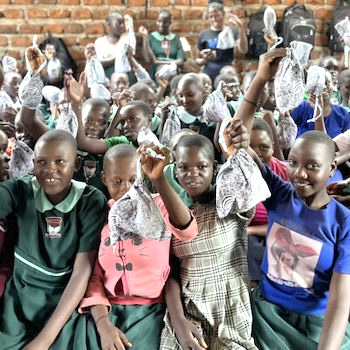 SAG Kit Distribution image showing Gods Grace Primary School girls receiving 287 kits in Kikyusa, Uganda on Feb 8, 2024
