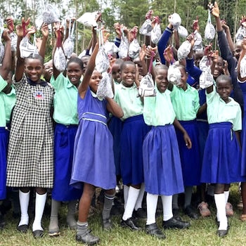 SAG Kit Distribution image showing St. Kizito Naluvule Primary School girls receiving 189 kits in Taddei, Uganda on Feb 15, 2024