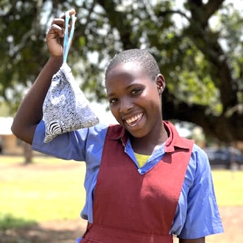 SAG Kit Distribution image showing Kibengo RC Primary School girls receiving 61 kits in Kikyusa, Uganda on Feb 22, 2024