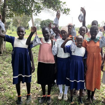 SAG Kit Distribution image showing Bumbu Primary School girls receiving 28 kits in Kikyusa, Uganda on Feb 22, 2024