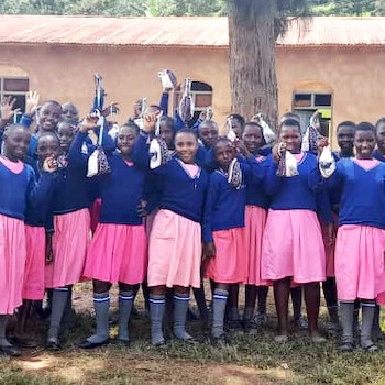SAG Kit Distribution image showing Rugomora Primary School girls receiving 52 kits in Bubare, Uganda on Apr 5, 2024