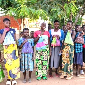 SAG Kit Distribution image showing Monrovia Refugee Camp School girls receiving 12 kits in Monrovia, Malawi on May 1, 2024