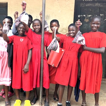 SAG Kit Distribution image showing Luwero Primary School girls receiving 168 kits in Kasana, Uganda on May 2, 2024