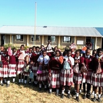 SAG Kit Distribution image showing Enkare Ngiro Secondary School girls receiving 70 kits in Ewasa Nyiro, Kenya on Jun 4, 2024