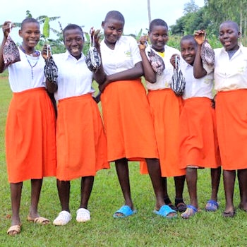 SAG Kit Distribution image showing Kibuzi Primary School girls receiving 77 kits in Kayunga, Uganda on Jun 13, 2024
