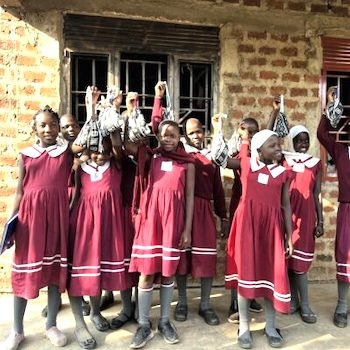 SAG Kit Distribution image showing Vision Junior School girls receiving 100 kits in Busula, Uganda on Jun 18, 2024