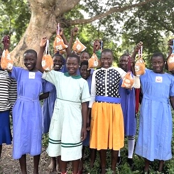 SAG Kit Distribution image showing Naibowa Primary School girls receiving 213 kits in Kabukye, Uganda on Aug 9, 2024