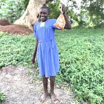 SAG Kit Distribution image showing Naibowa Primary School girls receiving 213 kits in Kabukye, Uganda on Aug 9, 2024