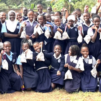 SAG Kit Distribution image showing Good Hope Primary School girls receiving 200 kits in Kyengera, Uganda on Aug 16, 2024