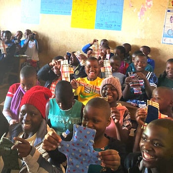 SAG Kit Distribution image showing Nkuringo School girls receiving 100 kits in Bwindi, Uganda on Sep 13, 2024