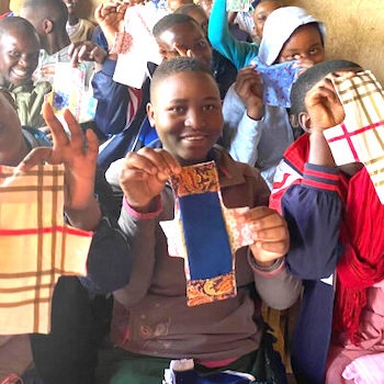 SAG Kit Distribution image showing Nkuringo School girls receiving 100 kits in Bwindi, Uganda on Sep 13, 2024