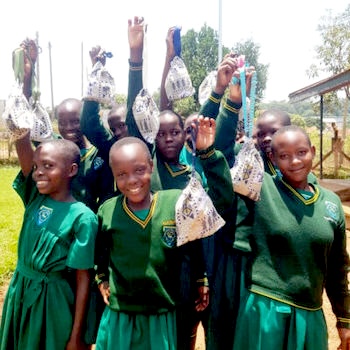 SAG Kit Distribution image showing Chadwick Namate Primary School girls receiving 147 kits in Entebbe, Uganda on Oct 1, 2024