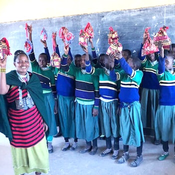 SAG Kit Distribution image showing Christopher Halloran Primary School girls receiving 18 kits in Loliondo, Tanzania on Oct 10, 2024
