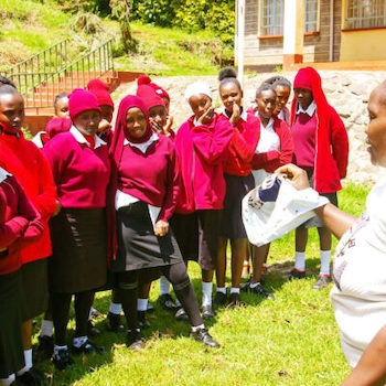 SAG Kit Distribution image showing Njoguini Secondary School girls receiving 125 kits in Ihururu, Kenya on Oct 22, 2024