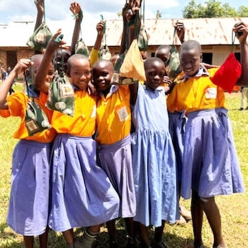 SAG Kit Distribution image showing Pearl Primary School girls receiving 181 kits in Nama, Uganda on Oct 25, 2024