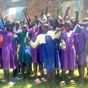 SAG Kit Distribution image showing Nkono Primary School girls receiving 72 kits in Ivukula, Uganda on Nov 15, 2024