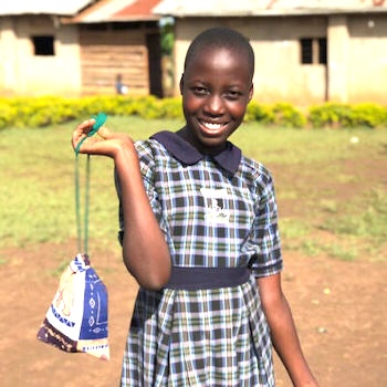 SAG Kit Distribution image showing Holy Trinity Primary School girls receiving 100 kits in Kyotera, Uganda on Nov 23, 2024