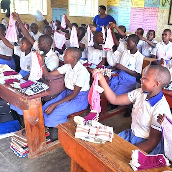 SAG Kit Distribution image showing Runengo Secondary School girls receiving 148 kits in Mbarara, Uganda on Mar 18, 2025