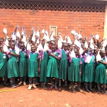 SAG Kit Distribution image showing Bualasa COU Primary School girls receiving 197 kits in Wobulenzi, Uganda on Mar 28, 2025