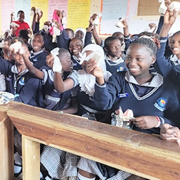 SAG Kit Distribution image showing St. Clever Junior School girls receiving 150 kits in Kalule, Uganda on Oct 8, 2025