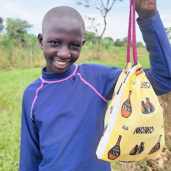 SAG Kit Distribution image showing St. Theresa Girls Primary School girls receiving 77 kits in Luwero, Uganda on Oct 16, 2025