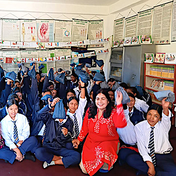 SAG Kit Distribution image showing Tribhuvan Janata Secondary School girls receiving 50 kits in Rukum, Nepal on Nov 12, 2025