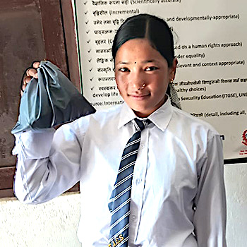 SAG Kit Distribution image showing Tribhuvan Janata Secondary School girls receiving 50 kits in Rukum, Nepal on Nov 12, 2025