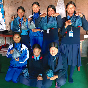 SAG Kit Distribution image showing Balkalyan Secondary School girls receiving 15 kits in Rolpa, Nepal on Nov 13, 2025