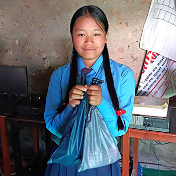 SAG Kit Distribution image showing Balkalyan Secondary School girls receiving 15 kits in Rolpa, Nepal on Nov 13, 2025