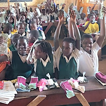 SAG Kit Distribution image showing Standard Page Primary School girls receiving 211 kits in Kitikamu, Uganda on Nov 21, 2025