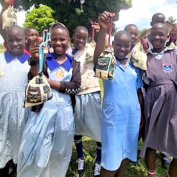 SAG Kit Distribution image showing Nabiteete Parents School girls receiving 150 kits in Bamunanika, Uganda on Feb 20, 2026