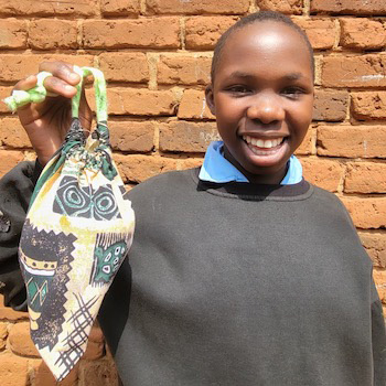 SAG Kit Distribution image showing Kibanga Primary School girls receiving 150 kits in Kalagala, Uganda on Mar 12, 2026