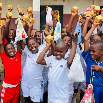 SAG Kit Distribution image showing Mercy Bilingual Primary School girls receiving 80 kits in Wonya, Cameroon on May 14, 2026