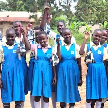 SAG Kit Distribution image showing St Kizitonatyole Primary School girls receiving 149 kits in Busiika, Uganda on May 26, 2026