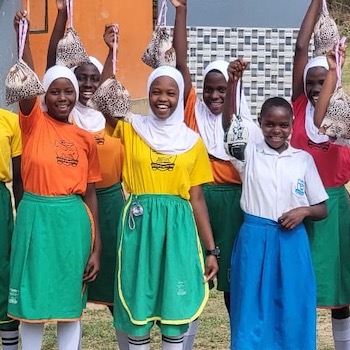 SAG Kit Distribution image showing Bombo Primary School girls receiving 150 kits in Bombo, Uganda on July 9, 2026