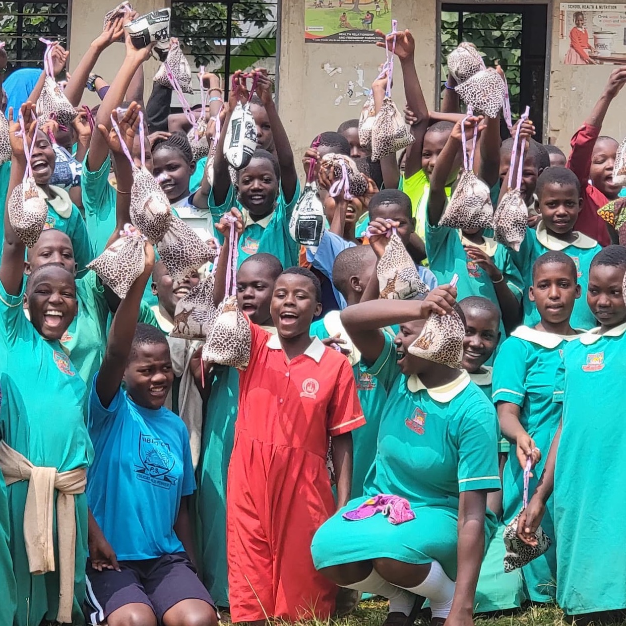 SAG Kit Distribution image showing Bibbo Primary School girls receiving 120 kits in Nansana, Uganda on July 9, 2026