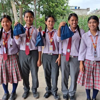 SAG Kit Distribution image showing Pragyan Academy girls receiving 122 kits in Dang, Nepal on July 20, 2026